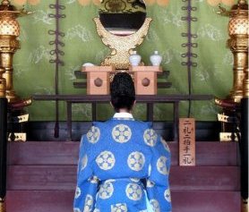 Priest in deep prayer on Dazaifu Tenmagu Shrine in Fukuoka, Japan, 2007