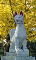 Stone fox statue with painted eyes and mouth